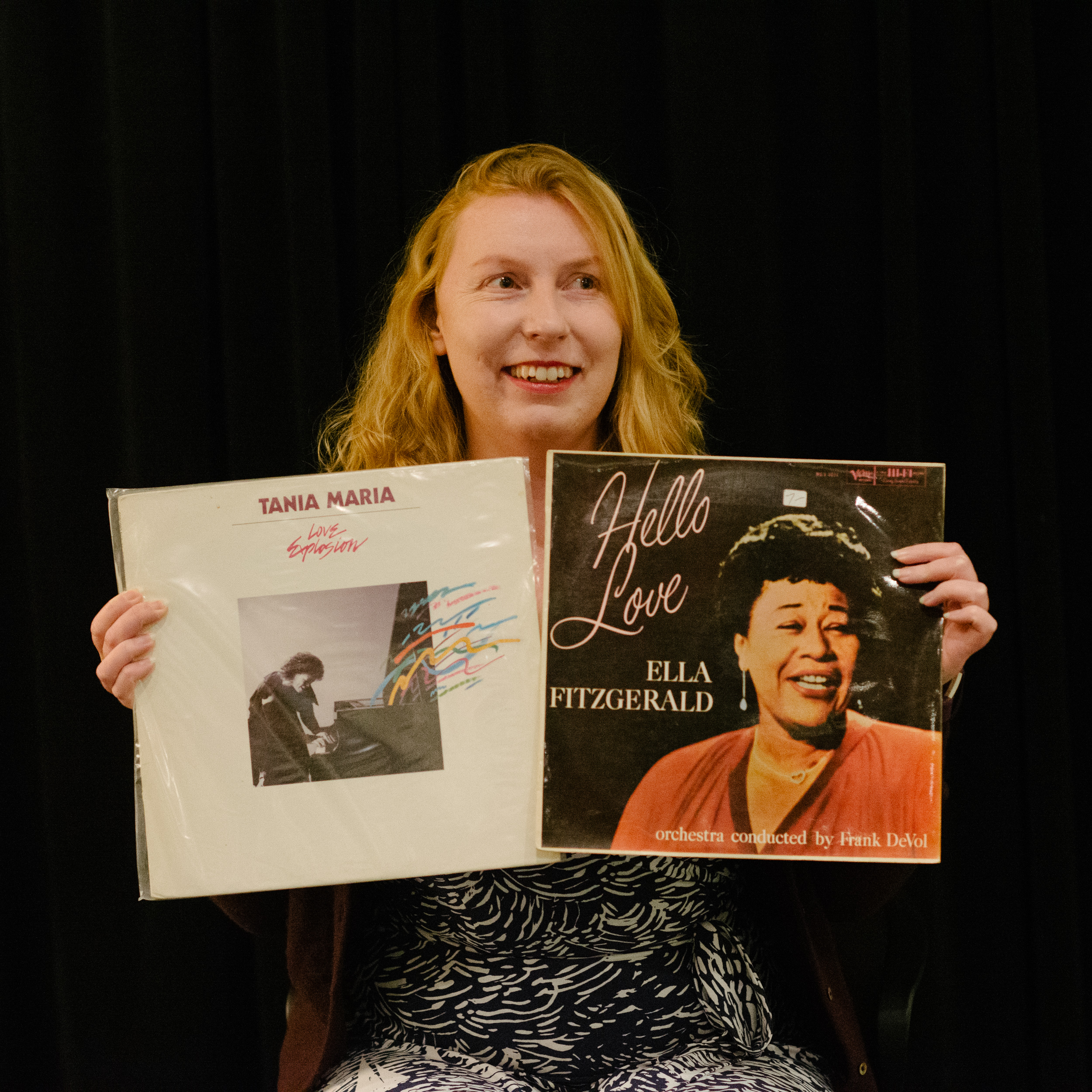 Photograph of Caroline holding two vinyls