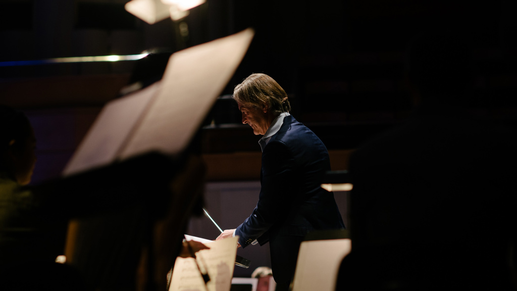 Conductor George Ellis in performance at Mimi's Symphony