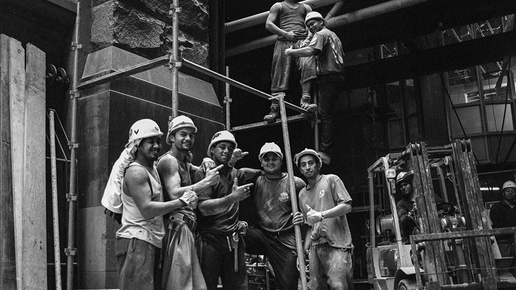 A black and white image of construction workers posing at the site of City Recital Hall. Image courtesy of City of Sydney Archives, Tim Cole Collection.