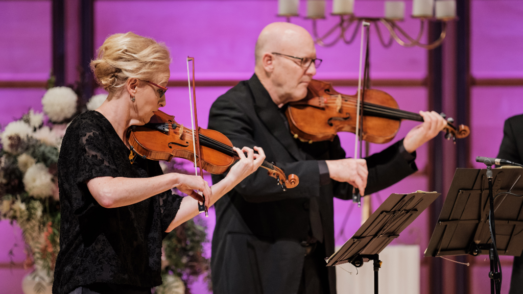 Violinist and violist performing on stage 